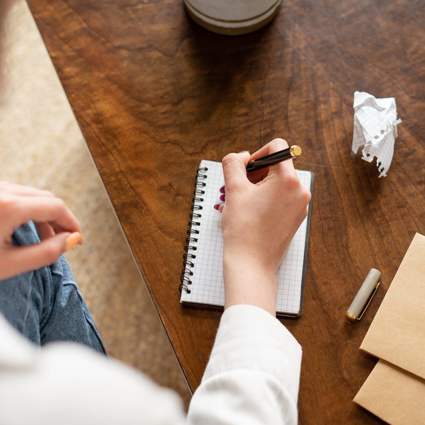 a-woman-s-hand-writes-with-a-pen-in-a-notebook-.jpg